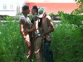 Trio en publico junto a las vias del tren