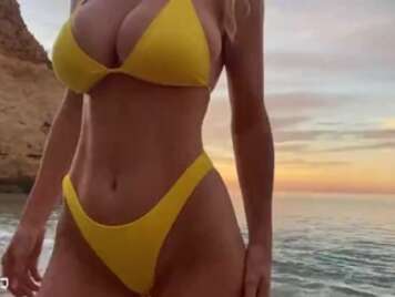 Bikini Eine vollbusige Blondine fickt am Strand