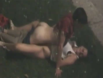 Una pareja se pone a follar en el cesped del parque sin sospechar que hay un voyeur grabandoles con el movil